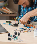 Person assembling electronics with 360 Degree Rotary Encoder Code Switch With Push Button, Five Pin Digital Potentiometer
