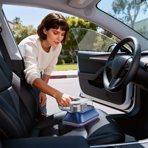 Woman using All-In-One Powerful Handheld Mattress Vacuum With Deep Vibration, UV-C Light, LED Display, And HEPA Filter in a car