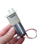 Mini Self Priming Diaphragm Water Pump 6V-12V With 370 Micro Motor DSB413-B shown in hand