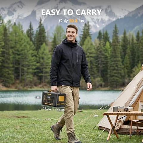 Man carrying Jump 1500X Portable Power Station With 110W Solar Panel Kit 828Wh LiFePO4 Battery near a tent by a lake and mountains.