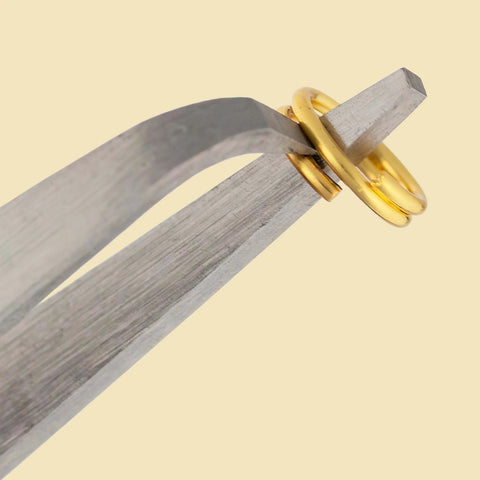 Split Ring Tweezers For Jewelry Making And Beading, Stainless Steel, 4.75 Inch Curved Precision Tip holding a gold split ring.