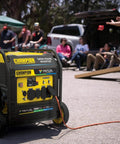 Outdoor view of 9000 Watt Tri Fuel Portable Open Frame Inverter Generator with electric start, CO Shield, and wheels for easy transport.