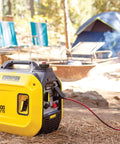 Ultralight 2500-Watt Portable Inverter Generator With Quiet Technology And CO Shield for camping, shown in campsite setup