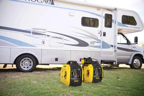 Ultralight 2500-Watt Portable Inverter Generator With Quiet Technology And CO Shield beside RV on grass