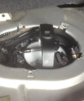 Universal Gas Tank Lock Ring Tool in use for fuel pump sender removal in vehicle trunk, showing close-up of tool applied.