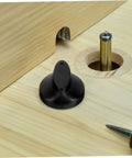 Black plastic Universal Timer Knobs Replacement for ovens, sterilizers, and rice cookers with precise timing, shown on wooden surface