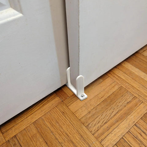 Universal ABS Sliding Door Floor Guide Set, 8 Pack For 1.375 Inch Thick Doors, white guide installed on wooden floor