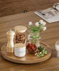 Acacia Wood Lazy Susan Turntable 10 Inch with various condiments and flowers on a wooden tabletop