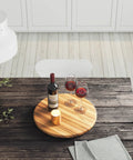 18 Inch Lazy Susan Kitchen Turntable in Acacia Wood for spices, condiments, on rustic table with wine, glasses, and candle.