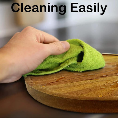Person cleaning 12 Inch Acacia Wood Lazy Susan Organizer For Cabinet And Pantry Kitchen Storage Turntable with a green cloth