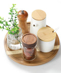 Acacia Wood Lazy Susan Turntable 10 Inch For Tabletop Kitchen with condiments and plant, 360-degree rotation, natural grain patterns.