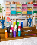 Acacia Wood 3 Tier Spice Rack For Cabinet Or Kitchen Expands From About 12 Inches To About 21 Inches With Clear View Spice Organizer With Adjustable Width Space Saving Tiered Storage TB Home displaying colorful paint bottles and brushes.