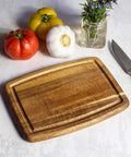 Must Have Acacia Wood Cutting Board With Juice Groove 8x6 Inch Small Kitchen Prep Board next to vegetables and knife