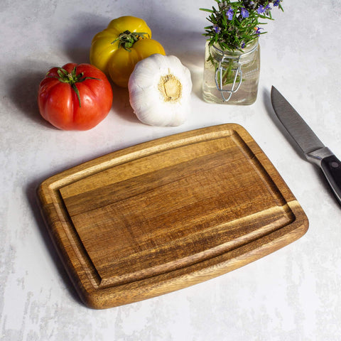 Must Have Acacia Wood Cutting Board With Juice Groove 8x6 Inch Small Kitchen Prep Board next to vegetables and knife