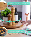 Hand using 12-Inch Acacia Wood Lazy Susan Turntable Organizer For Cabinets, Pantries, Countertops, with spices on kitchen table