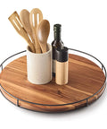 18-Inch Acacia Wood Lazy Susan Turntable With Metal Frame serving tray holding utensils and oil bottle on a kitchen countertop.