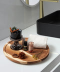 Acacia Wood Lazy Susan Turntable Organizer 8-Inch Round Rotating Serving Tray with aromatherapy bottles and towel on bathroom counter.