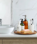 Bathroom setup with soap and dispensers on a 12-Inch Acacia Wood Lazy Susan Turntable Organizer for Cabinets, Pantries, Countertops.