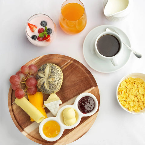 Breakfast setup with Acacia Wood Lazy Susan Turntable Organizer 8-Inch Round Rotating Serving Tray holding cheese, bread, and jam.