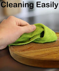 Hand cleaning 13 Inch Acacia Wood Lazy Susan Organizer For Kitchen Cabinets And Pantry Turntable With green cloth