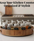 12 inch acacia wood lazy susan wooden turntable organizer with spice jars on kitchen counter.