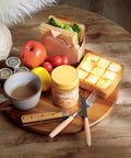18 inch acacia wood lazy susan cabinet organizer with food items, coffee, and condiments arranged on it.