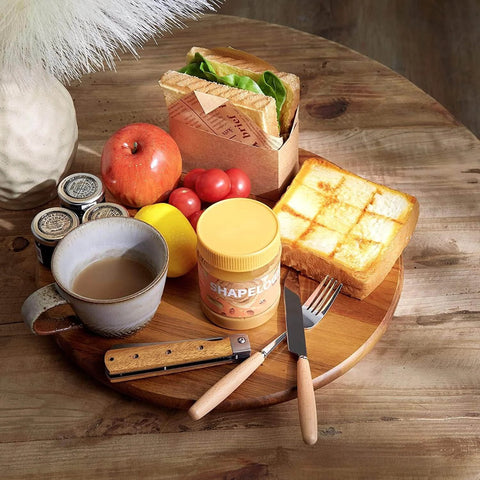 18 inch acacia wood lazy susan cabinet organizer with food items, coffee, and condiments arranged on it.