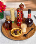 Acacia wood lazy susan organizer designed for kitchen and pantry use, featuring condiments and olives on a wooden turntable.