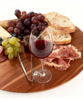 Acacia Wood Turntable Organizer Lazy Susan 21 Inch Rotating Tray set with wine, grapes, cheese, and meats on a table.