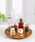 Acacia wood lazy susan organizer designed for kitchen and pantry use, featuring spices and garlic on a rotating wooden turntable.