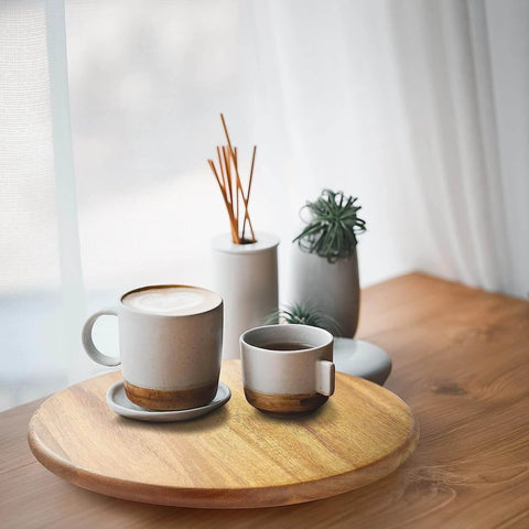 16 inch acacia wood lazy susan cabinet organizer with coffee cups and decorative vases on a wooden table.