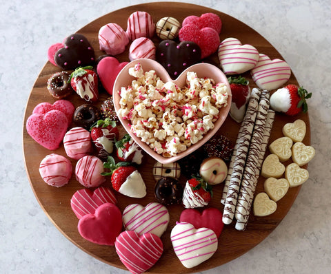 18 Inch Lazy Susan Kitchen Turntable In Acacia Wood For Spices And Condiments Displaying Assorted Chocolates and Popcorn