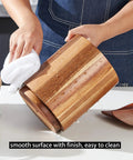 Acacia Wood Utensil Holder For Kitchen Countertop With 360 Degree Rotating Base being wiped clean on a kitchen counter