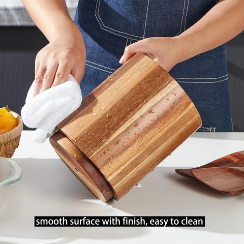 Acacia Wood Utensil Holder For Kitchen Countertop With 360 Degree Rotating Base being wiped clean on a kitchen counter