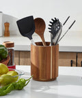 Acacia Wood Utensil Holder For Kitchen Countertop With 360 Degree Rotating Base overflows with cooking tools in a farmhouse kitchen.