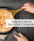 Person using spatula from 3 Piece Acacia Wood Kitchen Utensil Set With Spatula Slotted Spoon And Cooking Spoon For Flip Stir And Scoop In Nonstick Pans And Everyday Cooking Your Go To Tool For Home Chefs to flip crepe in nonstick pan.