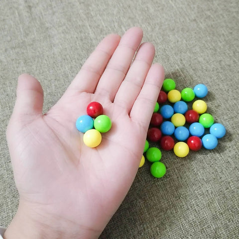 Hand holding 60Pcs Game Replacement Marbles Balls Compatible with Hungry Hungry Hippos, acrylic, colorful, 13.5mm diameter.