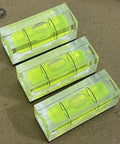 Three mini acrylic levels from Magnetic Square Bubble Spirit Levels Set 3 Pack for precise horizontal and vertical alignment.