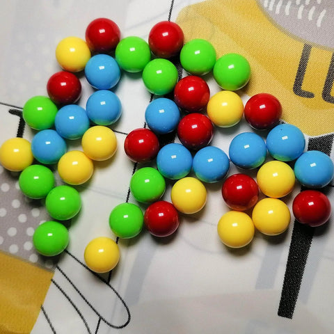 60Pcs Game Replacement Marbles Balls Compatible with Hungry Hungry Hippos in red, yellow, blue, green on patterned surface
