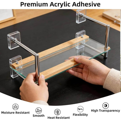 Person assembling a glass shelf with metal supports using premium acrylic adhesive on a black surface.