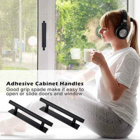 Woman sitting by window with tea and headphones, black self adhesive cabinet handles on window; 2 Pack Self Adhesive Cabinet Handles And Drawer Pulls