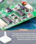 Close-up of Sticky PCB Spacers 100Pcs Adhesive Insulated Standoffs For PC Boards And Computer Motherboards 0.25 Inch Height Locking Snap In Posts