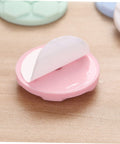 Close-up of one pink bumper pad from Five Pack Washing Machine Door Bumpers With Strong Adhesive Protective Pads For Washer Leveling And Wall Protection, Cushions That Stick Like Crazy And Help Prevent Wall Dings, Works With Most Front Load And Top Load Machines, Random Color, showing adhesive side.