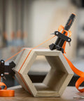 Adjustable Clamp Pony 1225 Rapid Acting Band Clamp With Non Marring 1x1 Inch Jaws For Irregular Shapes in use on hexagon wood piece