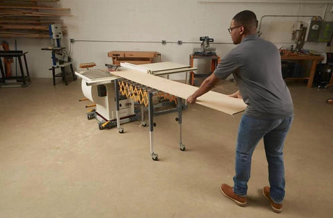 Person using Adjustable Conveyor Roller Stand Infeed / Outfeed Support Expandable Gravity Conveyor 300 lbs. Weight Capacity Locking Swivel Castor Wheels PM-2700 in workshop