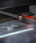 Adjustable universal file handle clamps to tool tang and fits multiple file sizes without inserts, showing file and saw blades