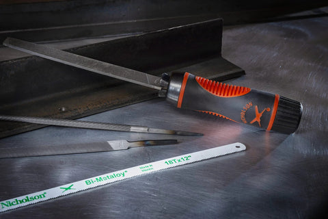 Adjustable universal file handle clamps to tool tang and fits multiple file sizes without inserts, showing file and saw blades