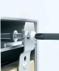 Close-up of an Adjustable Outlet Spacer 50pk being installed with a screwdriver, showing its metal and plastic components.