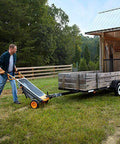 Man using 8 in 1 Heavy Duty Aerocart Garden Cart Wheelbarrow Dolly with Turbo Lift Design and Flat Free Tires to haul trailer