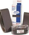 Abrasive sanding belts and packaging box, with brown belts in different rolled sizes, suitable for industrial sanding applications.